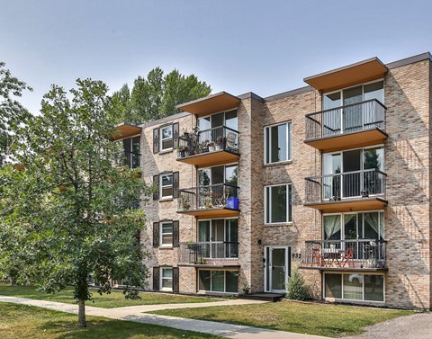 an image of a brick apartment building with balconies